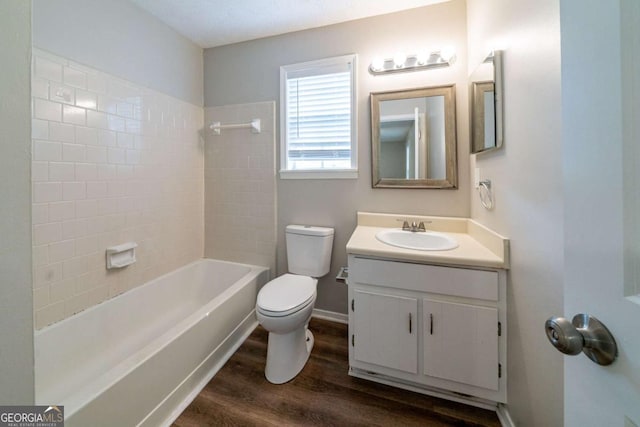 744 Brittany Ct, Stone Mountain, GA 30083 - bathroom featuring toilet, wood finished floors, shower / bathing tub combination, baseboards, and vanity