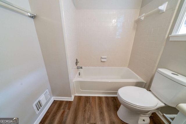 744 Brittany Ct, Stone Mountain, GA 30083 - full bathroom with shower / bath combination, toilet, visible vents, and wood finished floors
