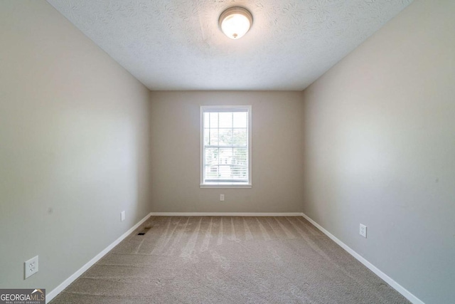 744 Brittany Ct, Stone Mountain, GA 30083 - unfurnished room with carpet, a textured ceiling, and baseboards