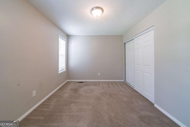 744 Brittany Ct, Stone Mountain, GA 30083 - unfurnished bedroom featuring carpet floors and a closet