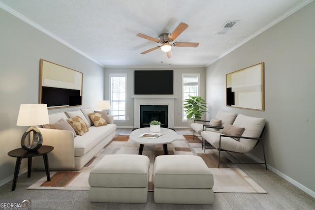 744 Brittany Ct, Stone Mountain, GA 30083 - carpeted living area with a fireplace, crown molding, visible vents, baseboards, and ceiling fan