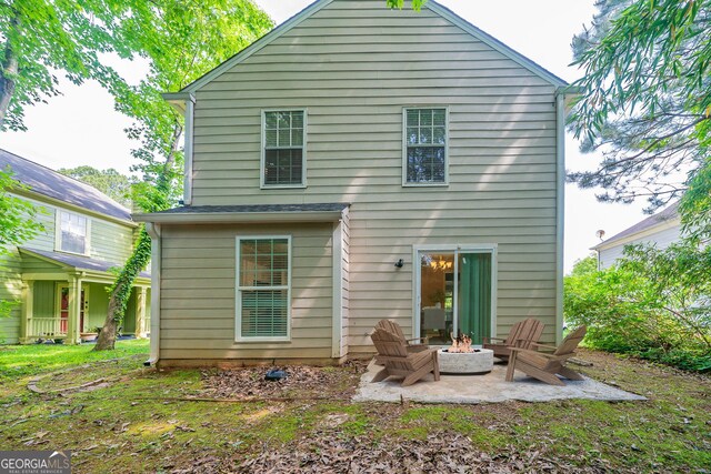 744 Brittany Ct, Stone Mountain, GA 30083 - rear view of property with an outdoor fire pit and a patio area