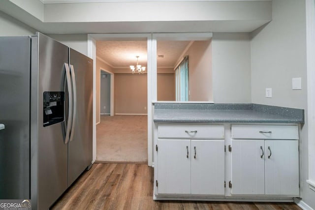 744 Brittany Ct, Stone Mountain, GA 30083 - kitchen featuring stainless steel fridge with ice dispenser, a chandelier, ornamental molding, wood finished floors, and white cabinets
