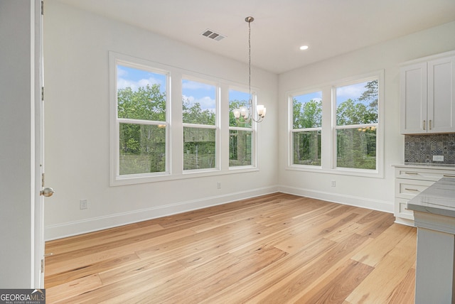 4039 Tallow Pl, Woodstock, GA 30188 - unfurnished dining area featuring visible vents, baseboards, an inviting chandelier, recessed lighting, and light wood-style flooring