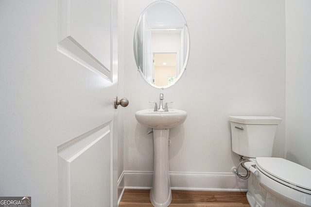 4039 Tallow Pl, Woodstock, GA 30188 - half bathroom featuring baseboards, wood finished floors, and toilet