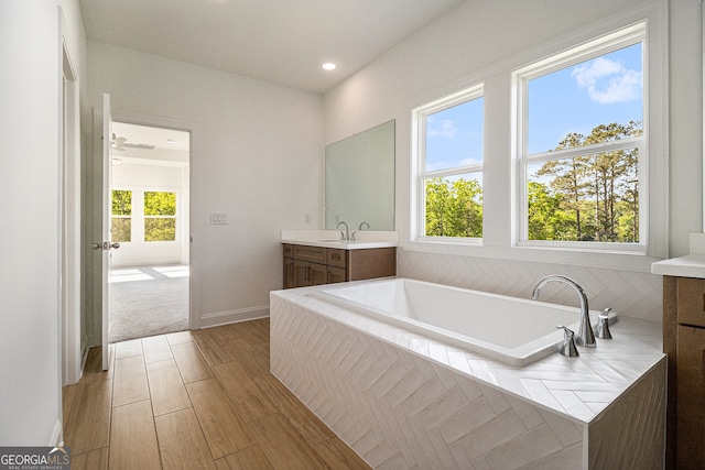 4039 Tallow Pl, Woodstock, GA 30188 - bathroom featuring recessed lighting, wood finished floors, a bath, and vanity