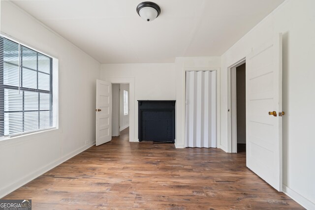 interior space with baseboards and wood finished floors