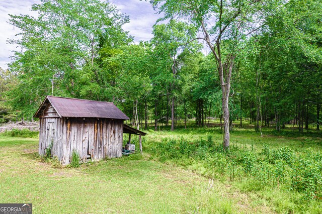 view of yard with a shed and an outbuilding