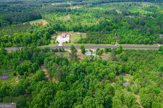 drone / aerial view with a wooded view