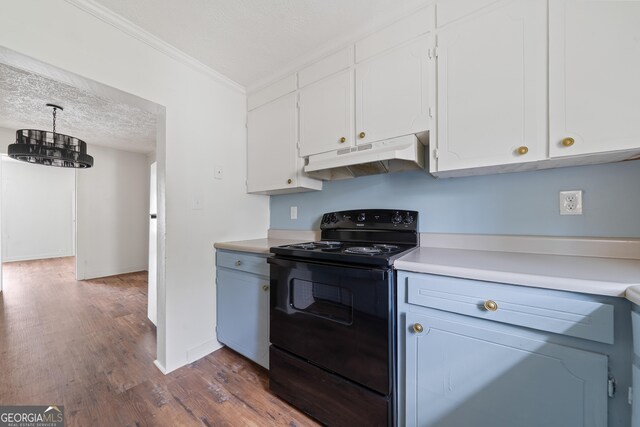 kitchen featuring dark wood-style floors, light countertops, white cabinetry, under cabinet range hood, and black / electric stove