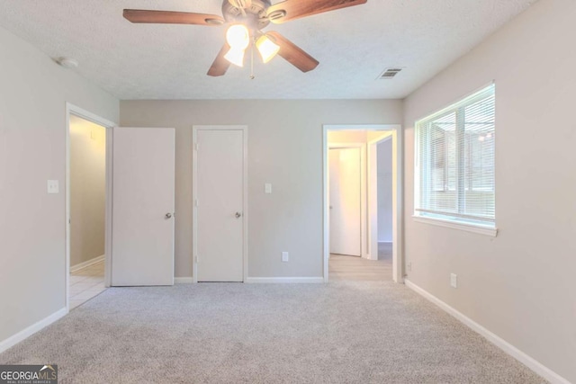 332 Cheryl Ct, Jonesboro, GA 30238 - unfurnished bedroom featuring carpet floors, baseboards, ceiling fan, and a textured ceiling