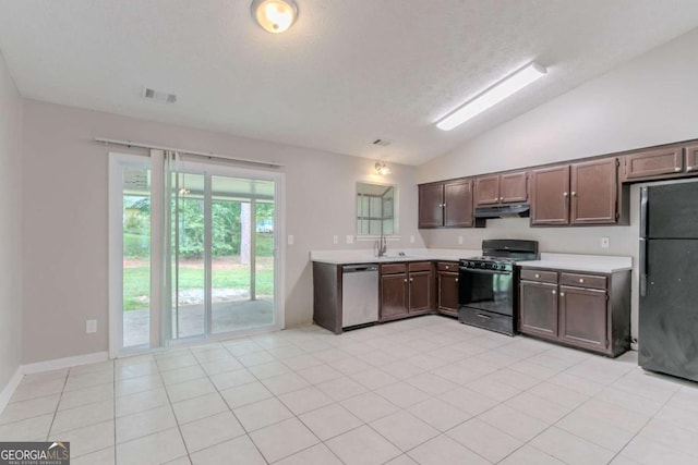332 Cheryl Ct, Jonesboro, GA 30238 - kitchen with black appliances, under cabinet range hood, light countertops, vaulted ceiling, and light tile patterned floors