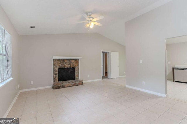 332 Cheryl Ct, Jonesboro, GA 30238 - unfurnished living room with ceiling fan, vaulted ceiling, a stone fireplace, light tile patterned floors, and baseboards