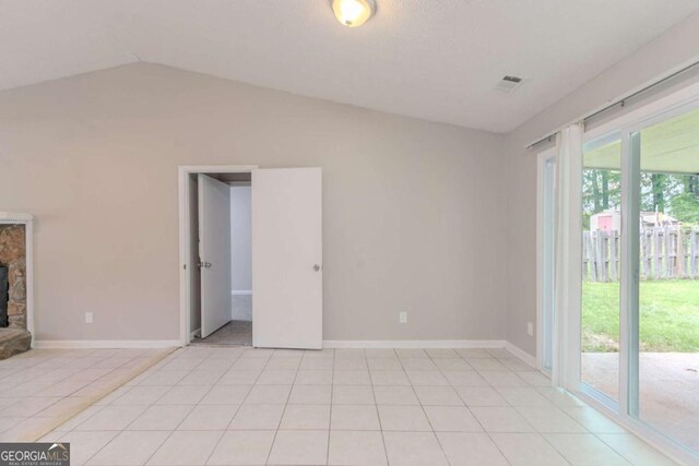 332 Cheryl Ct, Jonesboro, GA 30238 - unfurnished room featuring vaulted ceiling, a fireplace, light tile patterned floors, and baseboards