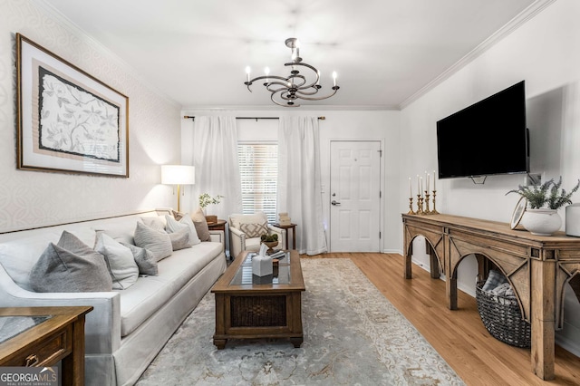 living room with crown molding, baseboards, an inviting chandelier, and wood finished floors