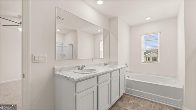 full bath featuring a sink, double vanity, a bath, and visible vents