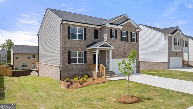 craftsman inspired home featuring brick siding, a garage, a front lawn, and driveway
