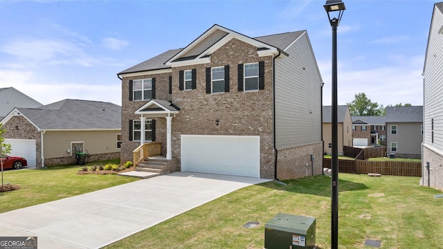 view of front facade with a front lawn, fence, brick siding, an attached garage, and driveway