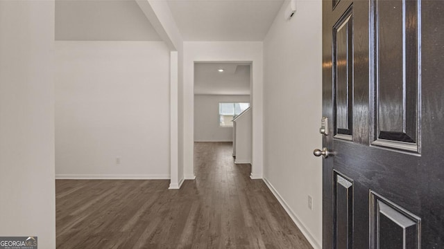 entrance foyer featuring baseboards and dark wood-style flooring