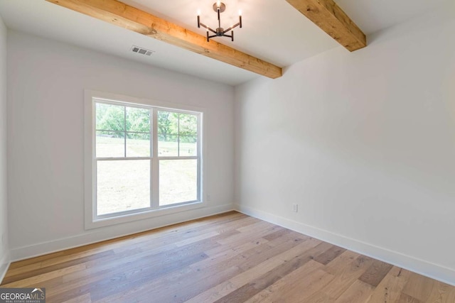 unfurnished room featuring baseboards, beamed ceiling, and light wood-type flooring