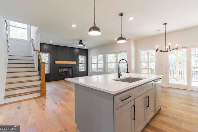 5734 Nix Bridge Rd, Gainesville, GA 30506 - kitchen featuring stainless steel dishwasher, light countertops, a large fireplace, light wood finished floors, and ceiling fan