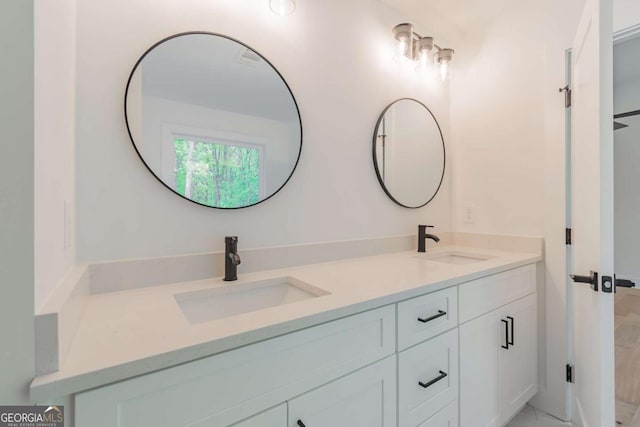 spare room featuring baseboards, light wood finished floors, visible vents, and vaulted ceiling