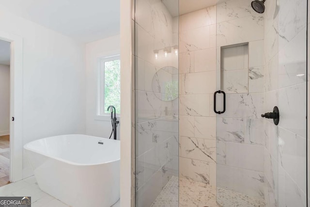 unfurnished bedroom featuring connected bathroom, baseboards, a spacious closet, and light wood-style floors