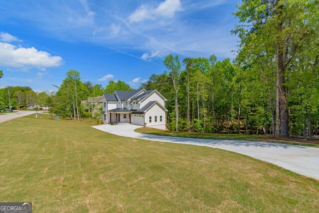 modern farmhouse style home featuring driveway and a front yard