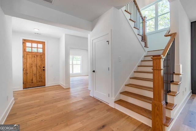 5734 Nix Bridge Rd, Gainesville, GA 30506 - foyer entrance with light wood-style flooring and stairs