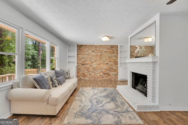 4420 Lake Breeze Dr, Stone Mountain, GA 30083 - living area with a textured ceiling, a healthy amount of sunlight, and a fireplace