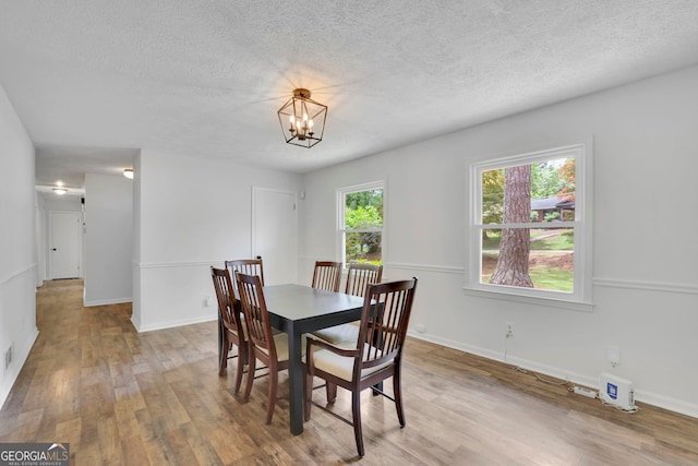 4420 Lake Breeze Dr, Stone Mountain, GA 30083 - dining room with an inviting chandelier, baseboards, a textured ceiling, and wood finished floors
