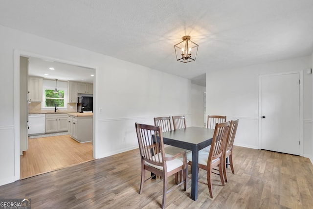 4420 Lake Breeze Dr, Stone Mountain, GA 30083 - dining room featuring an inviting chandelier, baseboards, and light wood-style flooring
