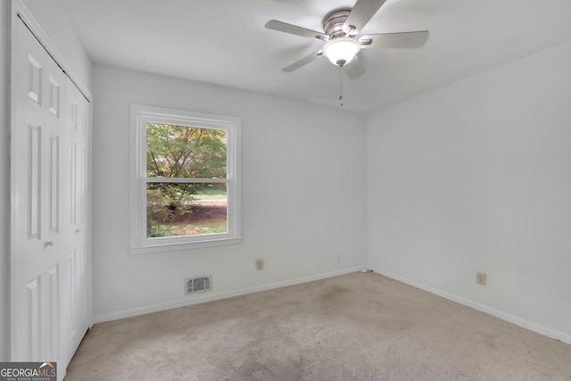 4420 Lake Breeze Dr, Stone Mountain, GA 30083 - unfurnished bedroom featuring a closet, baseboards, carpet flooring, and visible vents
