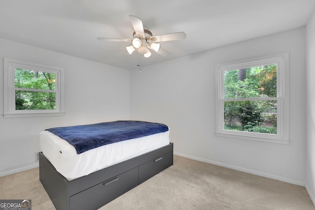 4420 Lake Breeze Dr, Stone Mountain, GA 30083 - bedroom with baseboards, ceiling fan, and light colored carpet