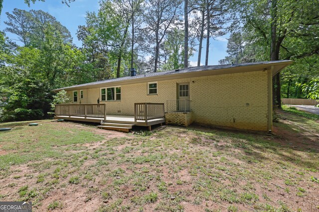 4420 Lake Breeze Dr, Stone Mountain, GA 30083 - back of property with brick siding, a lawn, and a wooden deck