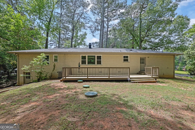 4420 Lake Breeze Dr, Stone Mountain, GA 30083 - rear view of property with brick siding, a lawn, central air condition unit, and a wooden deck
