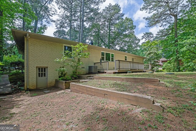4420 Lake Breeze Dr, Stone Mountain, GA 30083 - back of house with a deck and brick siding