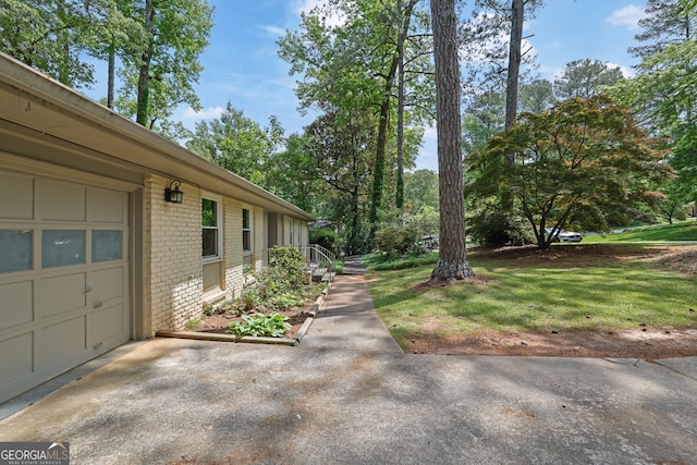 4420 Lake Breeze Dr, Stone Mountain, GA 30083 - view of side of home with brick siding and a garage