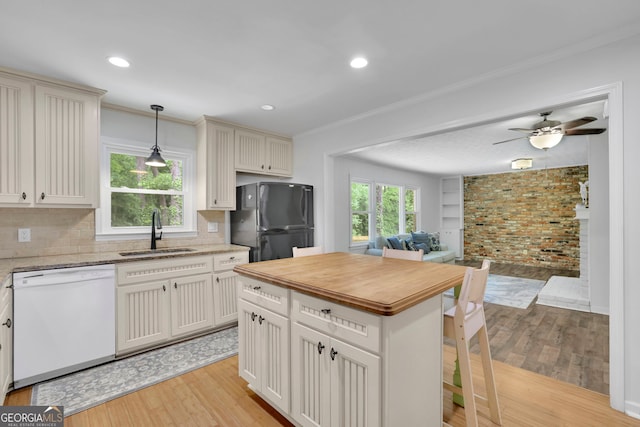 4420 Lake Breeze Dr, Stone Mountain, GA 30083 - kitchen featuring freestanding refrigerator, white dishwasher, a sink, light wood finished floors, and backsplash