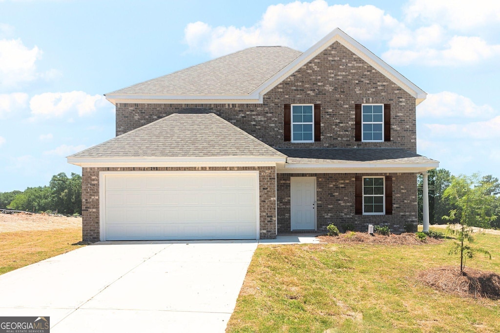 404 Clayton Scott St, Warner Robins, GA 31088 - view of front of house with a shingled roof, a front yard, and brick siding