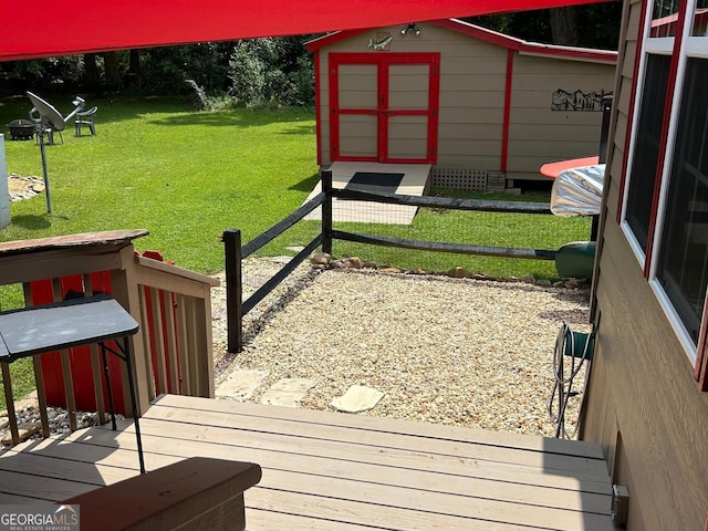wooden terrace with a lawn, an outdoor structure, and a storage shed