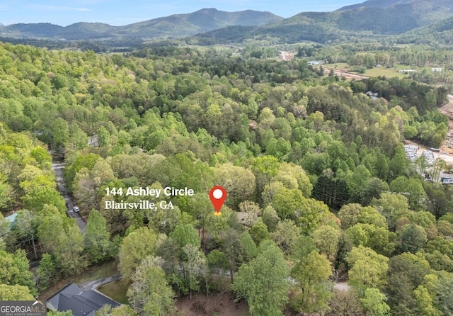 bird's eye view featuring a mountain view and a wooded view