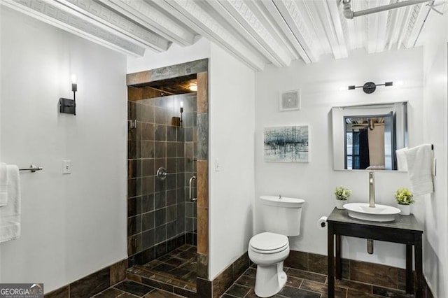 195 Arizona Ave Unit 104, Atlanta, GA 30307 - bathroom featuring stone tile flooring, toilet, baseboards, a shower stall, and a sink