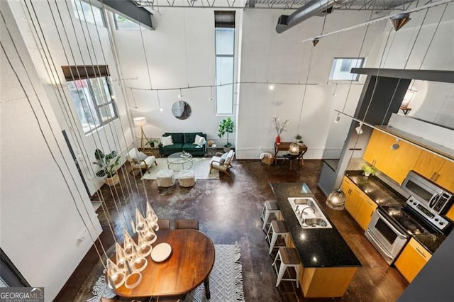 195 Arizona Ave Unit 104, Atlanta, GA 30307 - living room featuring concrete flooring and a towering ceiling