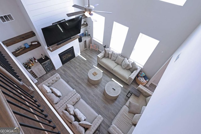 125 Leveret Rd, Locust Grove, GA 30248 - living room with a glass covered fireplace, a ceiling fan, and wood finished floors