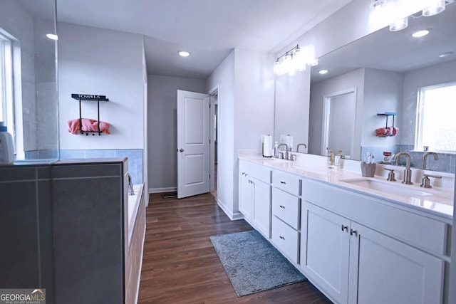 125 Leveret Rd, Locust Grove, GA 30248 - full bathroom with wood finished floors, double vanity, baseboards, recessed lighting, and a bathtub