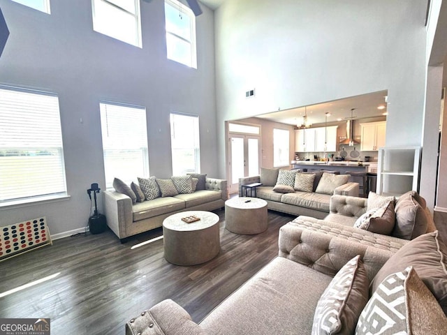 125 Leveret Rd, Locust Grove, GA 30248 - living room with a high ceiling, dark wood-type flooring, and baseboards