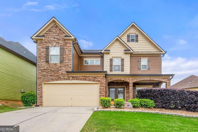 3755 Lake Haven Way, Atlanta, GA 30349 - view of front of home with driveway, an attached garage, stone siding, and a front yard