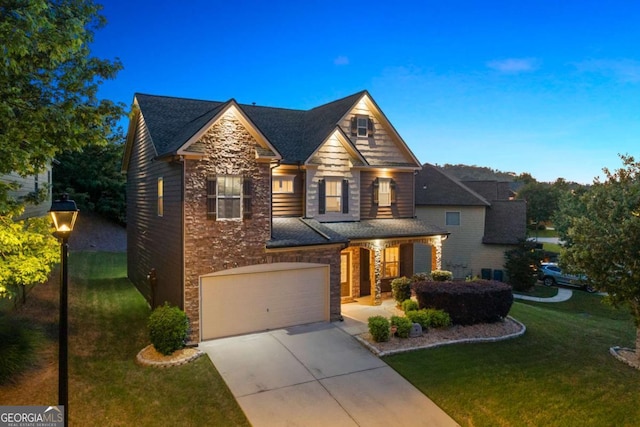 3755 Lake Haven Way, Atlanta, GA 30349 - view of front of house featuring stone siding, a front lawn, driveway, and an attached garage