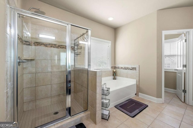3755 Lake Haven Way, Atlanta, GA 30349 - full bath featuring tile patterned flooring, a garden tub, healthy amount of natural light, and a shower stall